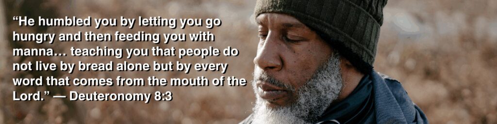 Reflective man in a winter beanie with the scripture “He humbled you by letting you go hungry and then feeding you with manna…” from Deuteronomy 8:3, representing the meaning of Deuteronomy 8.